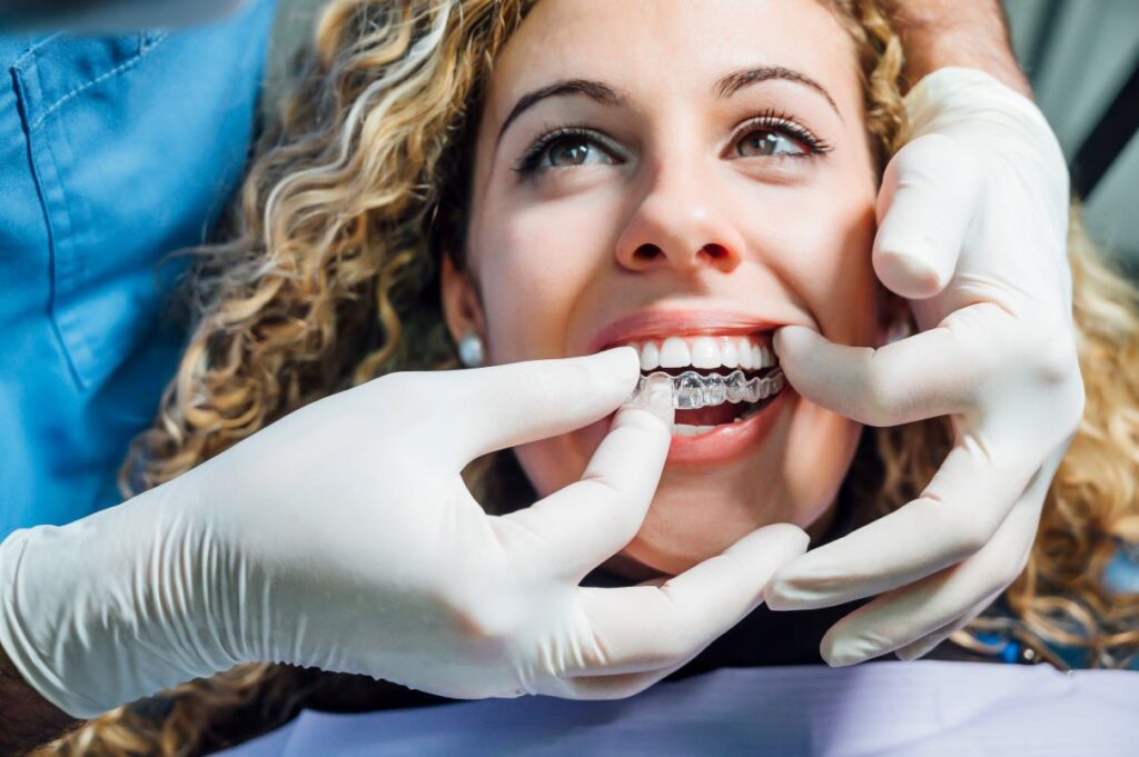 Woman getting invisalign aligners adjusted by an orthodontist